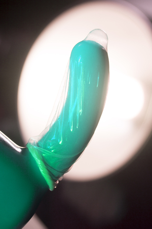 Rubber latex condom male contraceptive on dildo vibrator penis sex toy.の写真素材