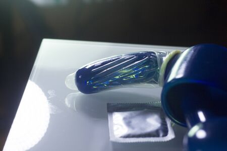 Rubber latex condom male contraceptive on dildo vibrator penis sex toy.の写真素材