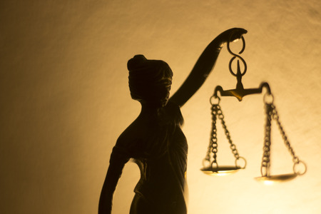 Legal law firm bronze statue of the goddess themis with scales of justice in attorneys office.の写真素材