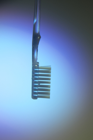 Dental toothbrush closeup isolated on abstract background
