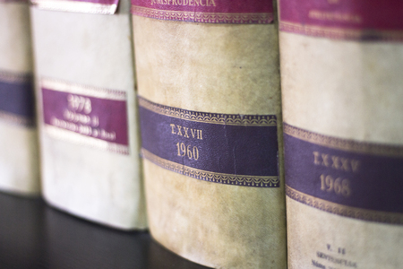 Old legal books law reports on shelves of law offices of attorneys and lawyers in judicial reference...