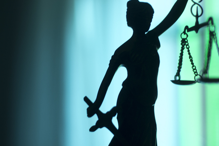 Legal law firm bronze statue of the goddess themis with scales of justice in attorneys office.の写真素材