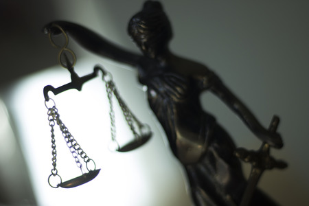 Legal law firm bronze statue of the goddess themis with scales of justice in attorneys office.の写真素材