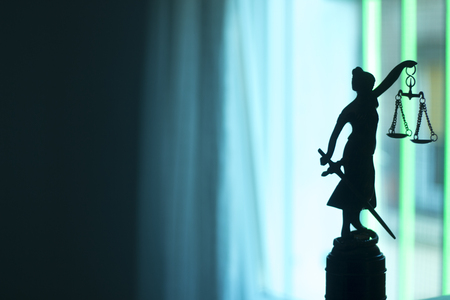 Legal law firm bronze statue of the goddess themis with scales of justice in attorneys office.の写真素材
