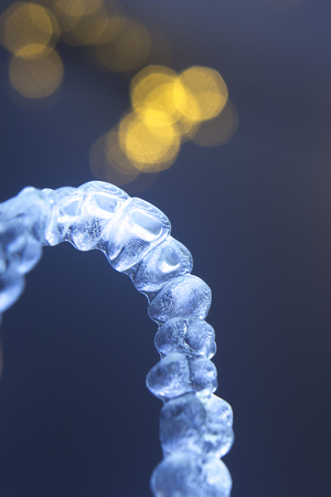 Invisible teeth retainers orthodontic brackets. Plastic modern straighterners to correct tooth alignment.の写真素材