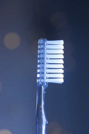 Dental toothbrush closeup isolated on abstract backgroundの写真素材