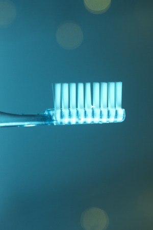 Dental toothbrush closeup isolated on abstract backgroundの写真素材