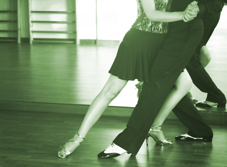 Ballroom dance couple of dancers and teachers in studio school dancing in rehearsal.の写真素材