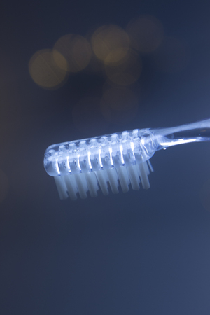 Dental toothbrush closeup isolated on abstract backgroundの写真素材