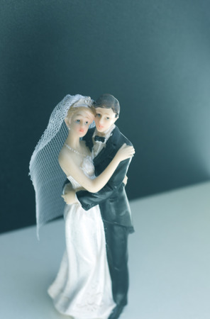Bride and bridegroom wedding cake topper plastic statues holding after marriage ceremony.の写真素材