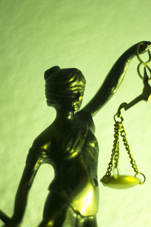 Legal law firm bronze statue of the goddess themis with scales of justice in attorneys office.の写真素材