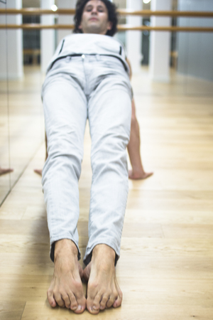 Man dancer dance  teacher stetching in gym fitness studio doing advanced bar stretch flexibility posture.の写真素材