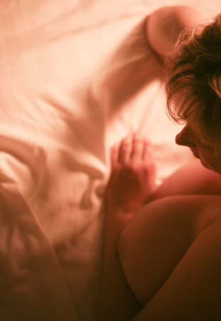 Sexy and erotic busty big naked breast sensual lady in seductive hot posing nude on bed sheets.の写真素材