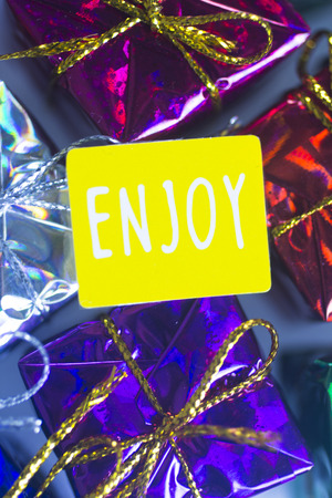 Christmas party celebration presents gift wrapped miniatures Enjoy tag.の写真素材