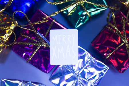 Xmas party celebration presents gift wrapped miniatures Merry Chritmas tag.