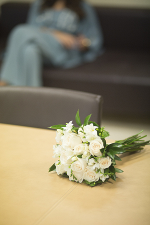 Civil non religious wedding ceremony registry office bridal bouquet of roses flowers of the bride.の写真素材