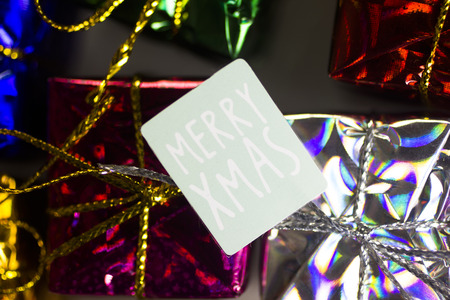 Xmas party celebration presents gift wrapped miniatures Merry Chritmas tag.