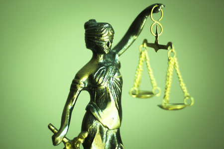 Legal law firm bronze statue of the goddess themis with scales of justice in attorneys office.の写真素材