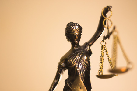 Legal law firm bronze statue of the goddess themis with scales of justice in attorneys office.の写真素材
