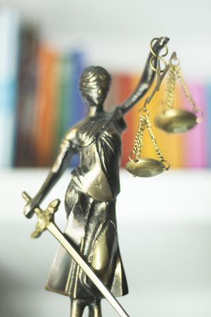 Legal law firm bronze statue of the goddess themis with scales of justice in attorneys office.の写真素材