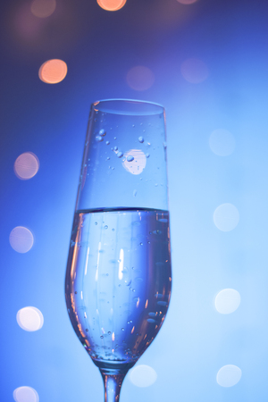 Champagne sparkling wine glass of prosecco cava in discotque party bar during wedding in Ibiza Spain with lights behind.の写真素材