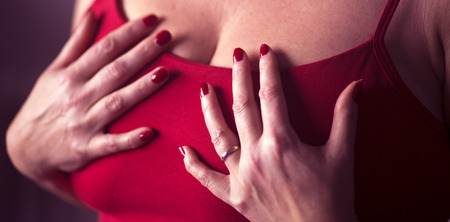 Busty slim sexy lady with very big erotic breasts and massive cleavage posing as adult model in photo shoot.の写真素材