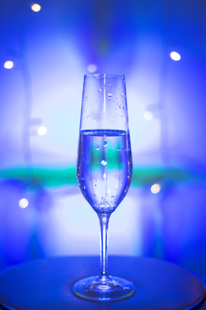 Champagne sparkling wine glass of prosecco cava in discotheque party bar during wedding in Ibiza Spain with lights behind.の写真素材