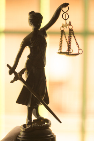 Legal law firm bronze statue of the goddess themis with scales of justice in attorneys office.の写真素材