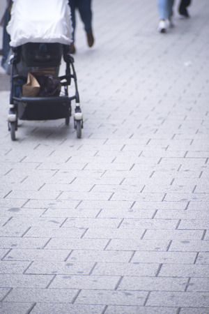 People walking in busy urban city shopping street sidewalk pavement shoes feet and legs with...