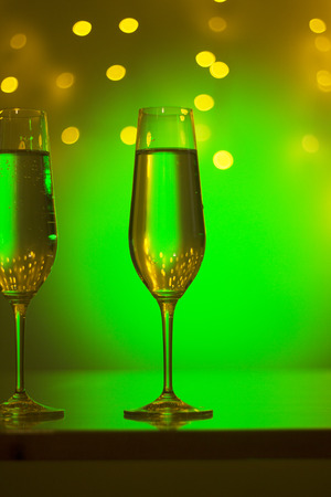 Champagne sparkling wine glasses of prosecco cava in nightclub party bar during wedding in Ibiza Spain with lights behind.の写真素材