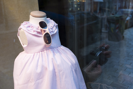 Womenswear fashion shop window ladies store mannquins dummies wearing fashionable wedding party dress.の写真素材
