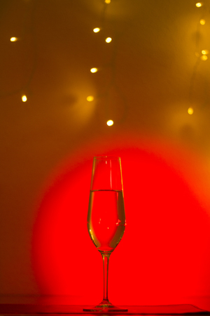 Champagne sparkling wine glass of prosecco cava in discotque party bar during wedding in Ibiza Spain with lights behind.の写真素材