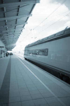 High speed modern bullet passenger train in station by platform in Spain.のeditorial素材