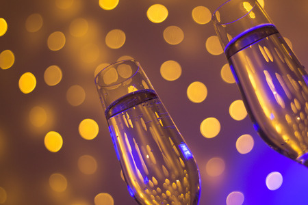 Champagne sparkling wine glasses of prosecco cava in nightclub party bar during wedding in Ibiza Spain with lights behind.の写真素材