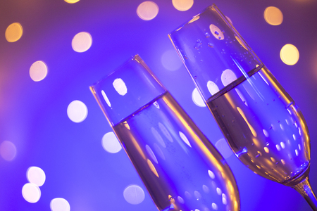Champagne sparkling wine glass of prosecco cava in discotque party bar during wedding in Ibiza Spain with lights behind.の写真素材