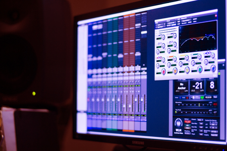 Recording studio digital mixing desk screen used to mix voiceover voice, singing and music.