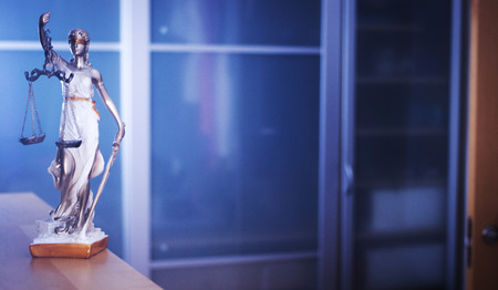 Law office legal justice statue of blind goddess Themis with scales in lawyers office.の写真素材