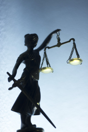 Legal law firm bronze statue of the goddess Themis with scales of justice in attorneys office.の写真素材