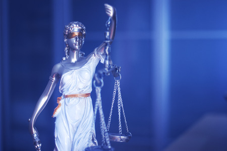 Law office legal justice statue of blind goddess Themis with scales in lawyers office.の写真素材