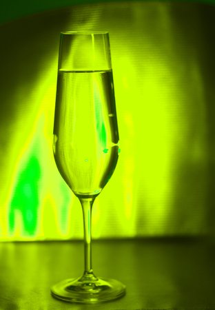 Champagne sparkling wine glass of prosecco cava in discotque party bar during wedding in Ibiza Spain with lights behind.の写真素材