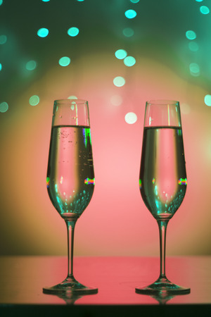 Champagne sparkling wine glasses of prosecco cava in nightclub party bar during wedding in Ibiza Spain with lights behind.の写真素材