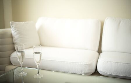 Luxury modern style hotel suite bedroom with bed, sheets, pillows clean and ready for guests.