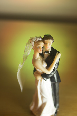 Wedding couple marriage cake topper plastic figures with tuxedo evening suit, white weddding dress veil.の写真素材