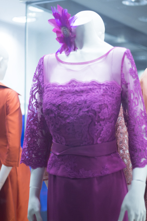 Bridal shop dummy female guest mannequin in department store with color formal long party dress.の写真素材