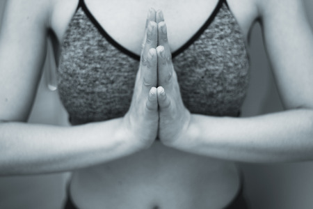 Female instructor yoga teacher teaching asana pose with mudra hand posture.の写真素材