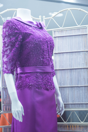 Bridal shop dummy female guest mannequin in department store with color formal long party dress.の写真素材