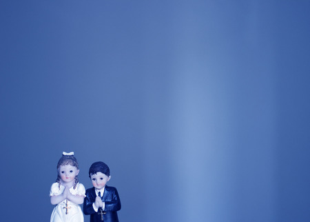 Cake topper Catholic holy communion ceremony religious boy and girl praying to Christian God in church.の写真素材