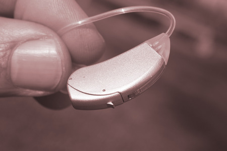 Modern compact in the ear digital audiophone hearing aid for deaf  people to hear.