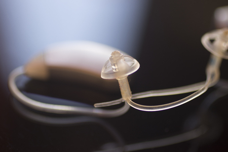 Audiophone modern high technology deafness equipment in the ear digital hearing aid closeup isolated.の写真素材