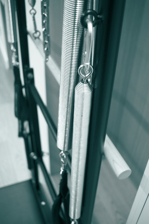 Pilates machine fitness studio gym room with training machinesの写真素材